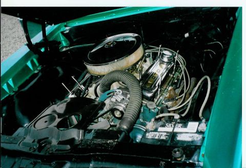 1967 Pontiac Lemans - The engine bay of a 1967 Pontiac Lemans, its V8 engine and battery, is visible in this photograph.
