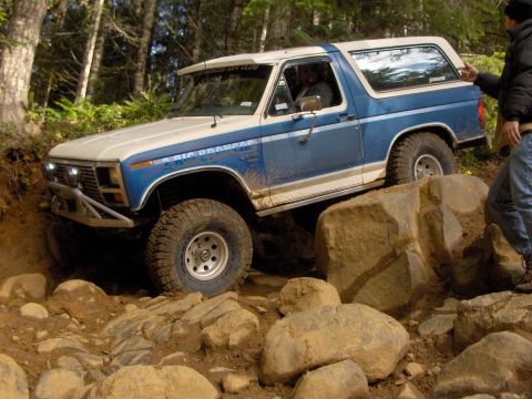 1978 Ford Bronco - This 1978 Ford Bronco is shown tackling a challenging off-road course with large rocks.