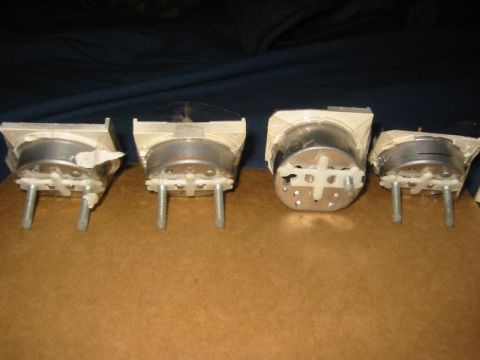 1985 Ford Bronco - A collection of four automotive gauges, each a clear protective cover and a metallic housing.