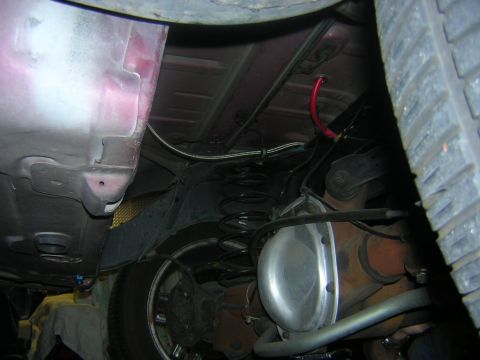 1992 Ford Crown Victoria - A close-up view of a car's underbody, revealing suspension components and a rear differential.
