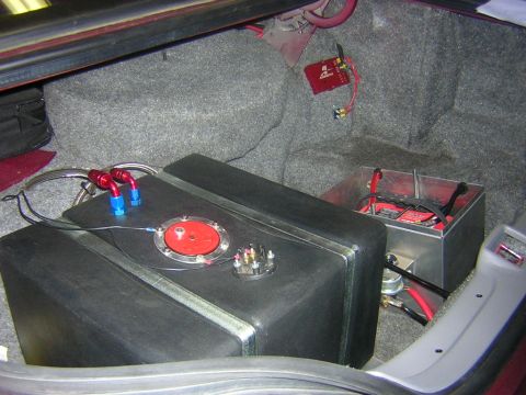 1992 Ford Crown Victoria - Aftermarket fuel cell and battery installed in the trunk of a car.