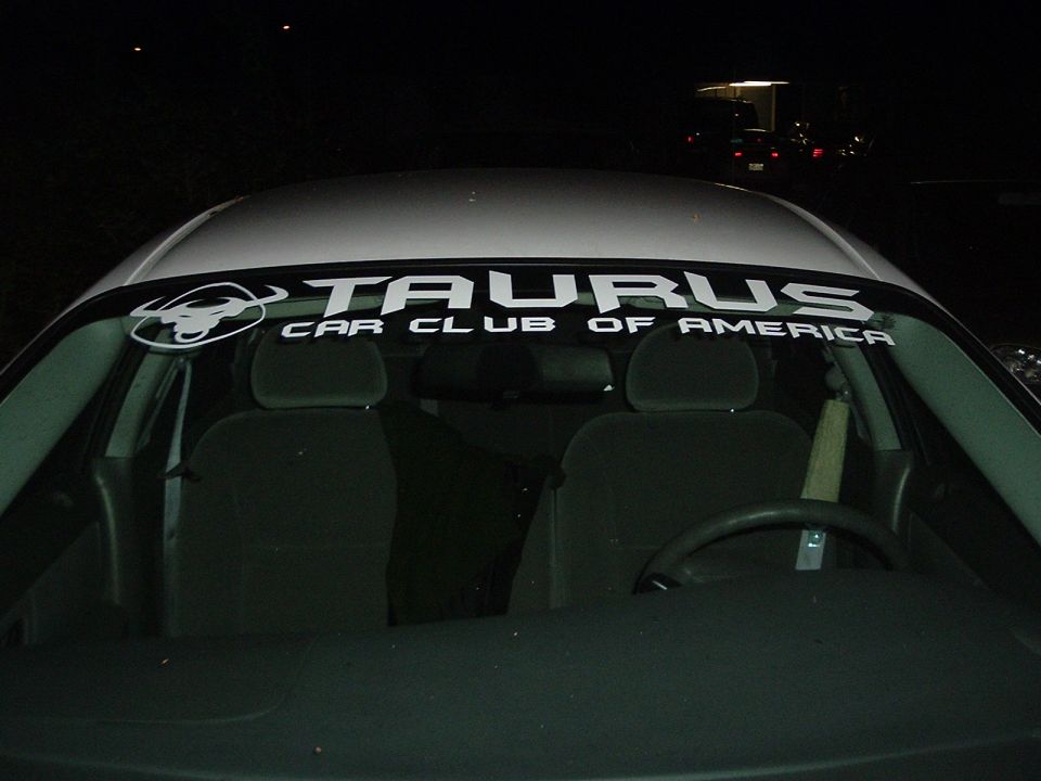 Car interior with Taurus Car Club of America banner on windshield