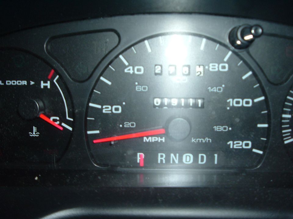 Car dashboard with speedometer, odometer showing 019111, and gear selector in Park