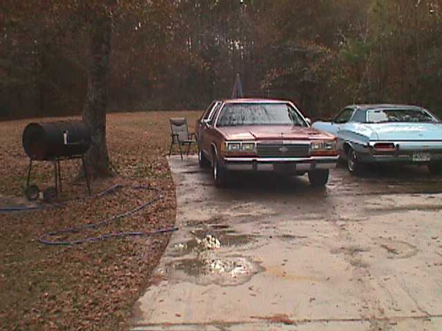 Red 1994 Ford Crown Victoria front view, parked next to a blue car