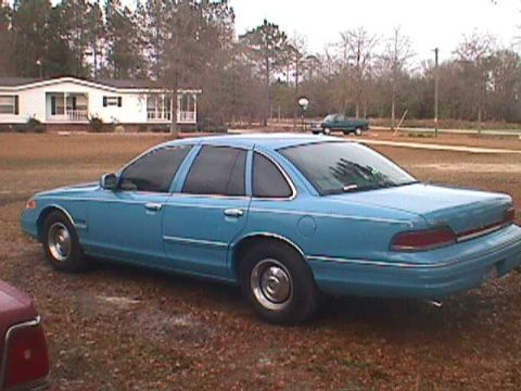 1994 Ford Crown Victoria - Blue 1994 Ford Crown Victoria sedan seen from the rear three-quarter angle.