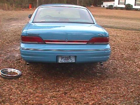 1994 Ford Crown Victoria - Rear view of a blue 1994 Ford Crown Victoria parked on a gravel lot.