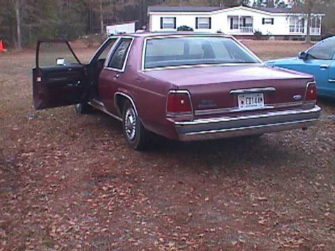 1994 Ford Crown Victoria - Maroon 1994 Ford Crown Victoria parked with front driver and passenger doors open, next to a blue vehicle.