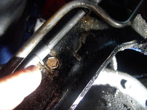 1986 Ford Bronco - Slacking off this half inch cooler pipe retaining clamp bolt helps get the hoses off and on. Just remember to re-tighten it later.