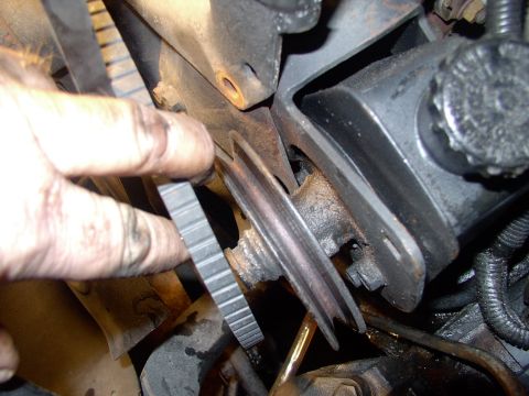 1986 Ford Bronco - Off comes the belt and out comes the pump, leaking and spilling all over the place.