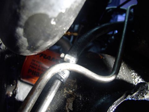 1986 Ford Bronco - Now that the flushing is done I removed the clear hose and installed the new PS hose with two opposed hose clamps as seen here.