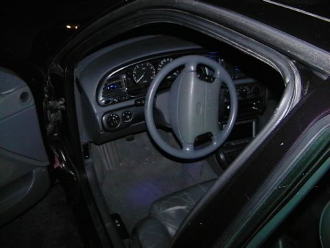 1995 Ford Contour - Interior view of a 1995 Ford Contour, showing the dashboard, steering wheel, and seats.