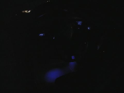 1995 Ford Contour - Interior shot of a car with blue ambient lighting on the floor.