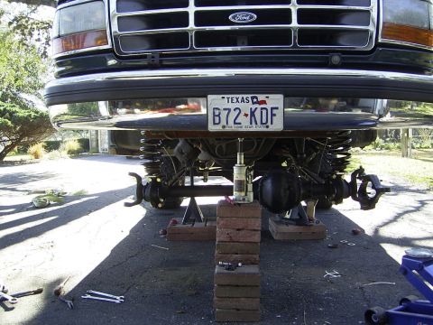 1995 Ford Bronco - This Ford truck is undergoing maintenance with its front end elevated for access to the suspension and drivetrain components.