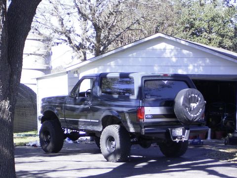 1995 Ford Bronco - This lifted 1995 Ford Bronco is parked outside a garage.