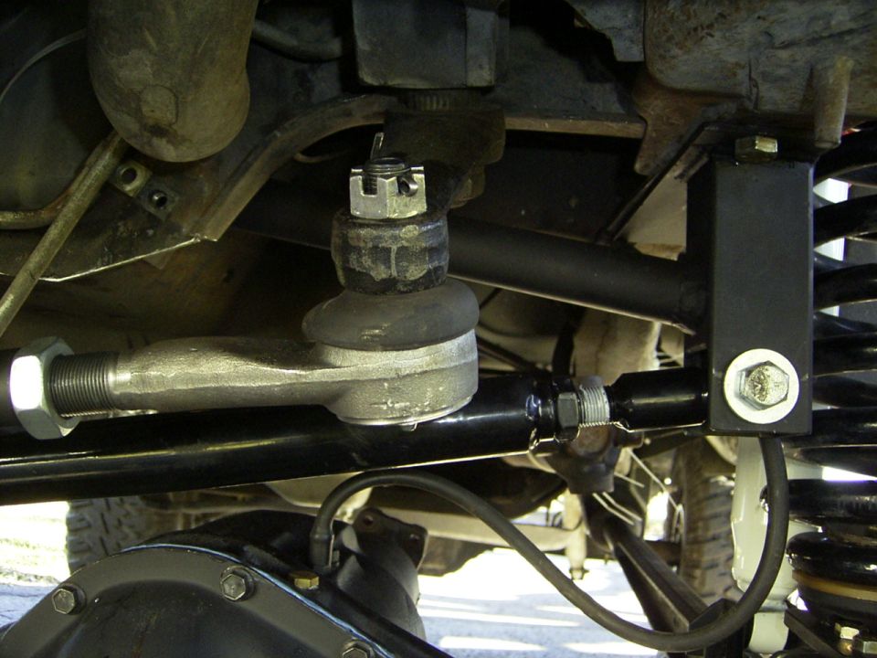 close-up of vehicle steering linkage and suspension components