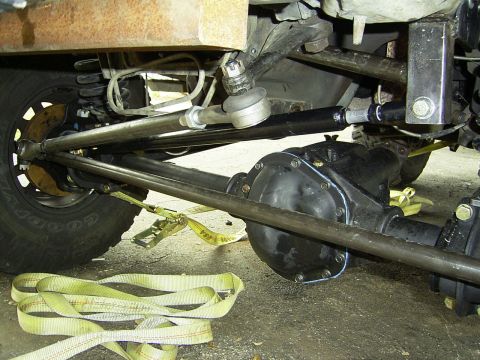 1995 Ford Bronco - Undercarriage view of a vehicle's steering and suspension system, with a focus on the front axle and differential.
