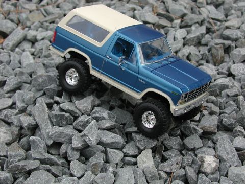 1985 Ford Bronco - Model of a 1985 Ford Bronco sits on a bed of grey rocks.