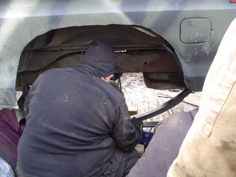1990 Ford Bronco - Working on the rear leaf springs of a vehicle, likely during a repair or modification.