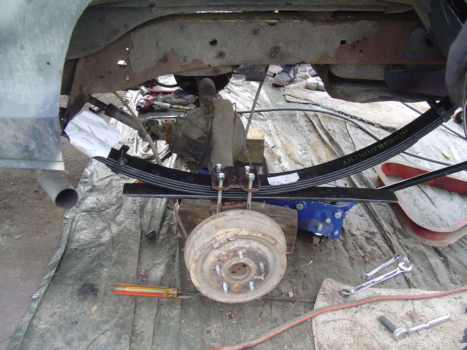 Rear leaf springs and drum brake assembly on a vehicle undergoing repair