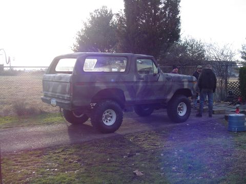 1990 Ford Bronco - This lifted Ford Bronco features a camouflage paint scheme and white-rimmed off-road tires.