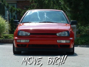 1994 Volkswagen Jetta - A red hatchback is parked outside with greenery in the background.