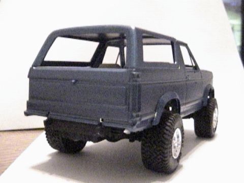 1979 Ford Bronco - Model SUV rear view shows large tires and a dark gray body.