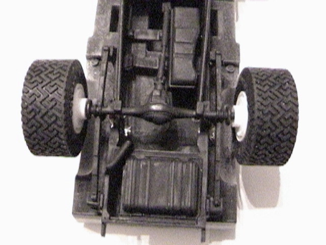 Model truck underside from rear showing rear axle, leaf springs, fuel tank and tires