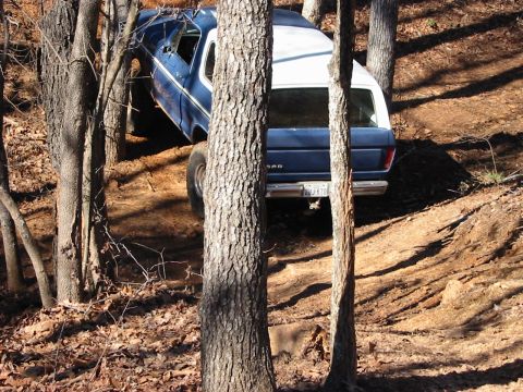 1978 Ford Bronco - This 1978 Ford Bronco navigates a wooded trail, showing its rear end as it goes off-road.