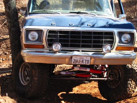 1978 Ford Bronco - Front view of a 1978 Ford Bronco with off-road suspension and aftermarket shocks.