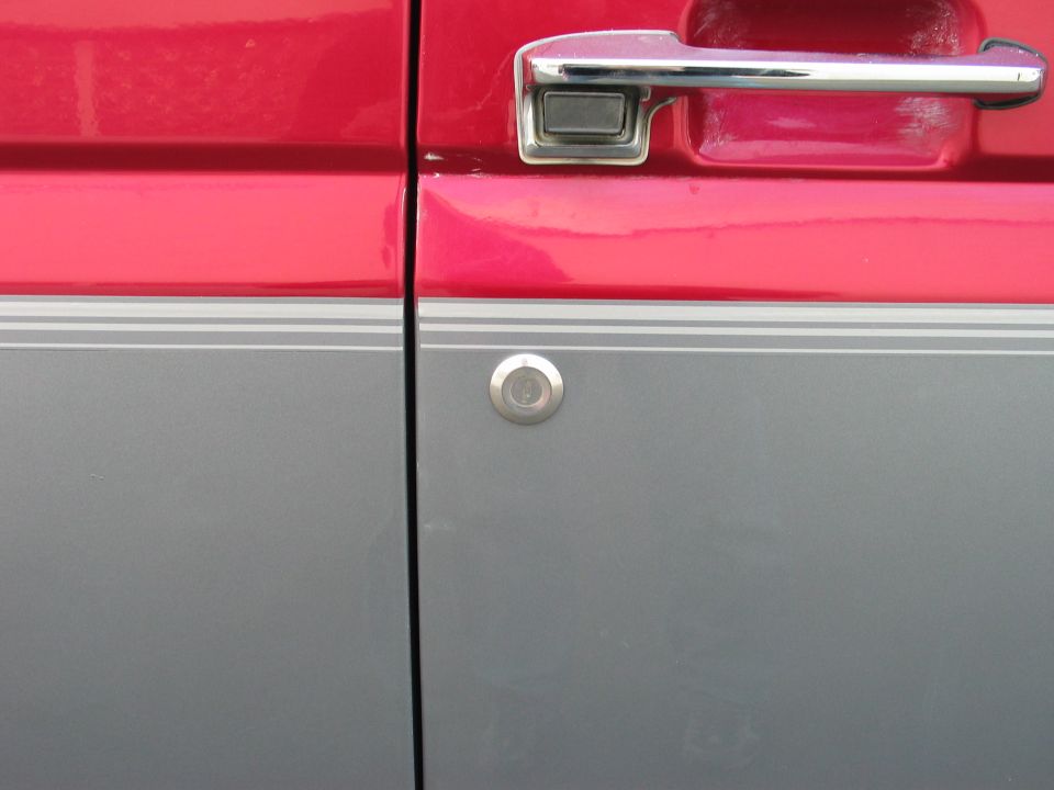 1995 Ford Bronco side door with chrome handle and two-tone paint