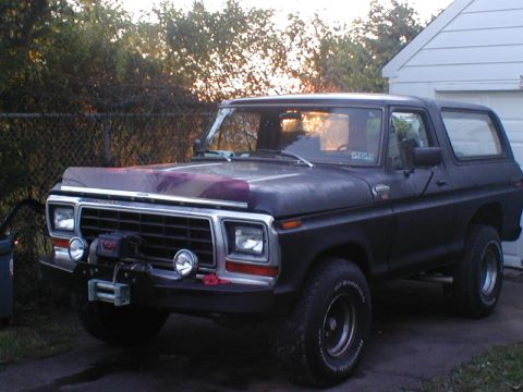 1979 Ford Bronco - This Ford Bronco has a winch and custom paint on the hood, parked in a driveway.