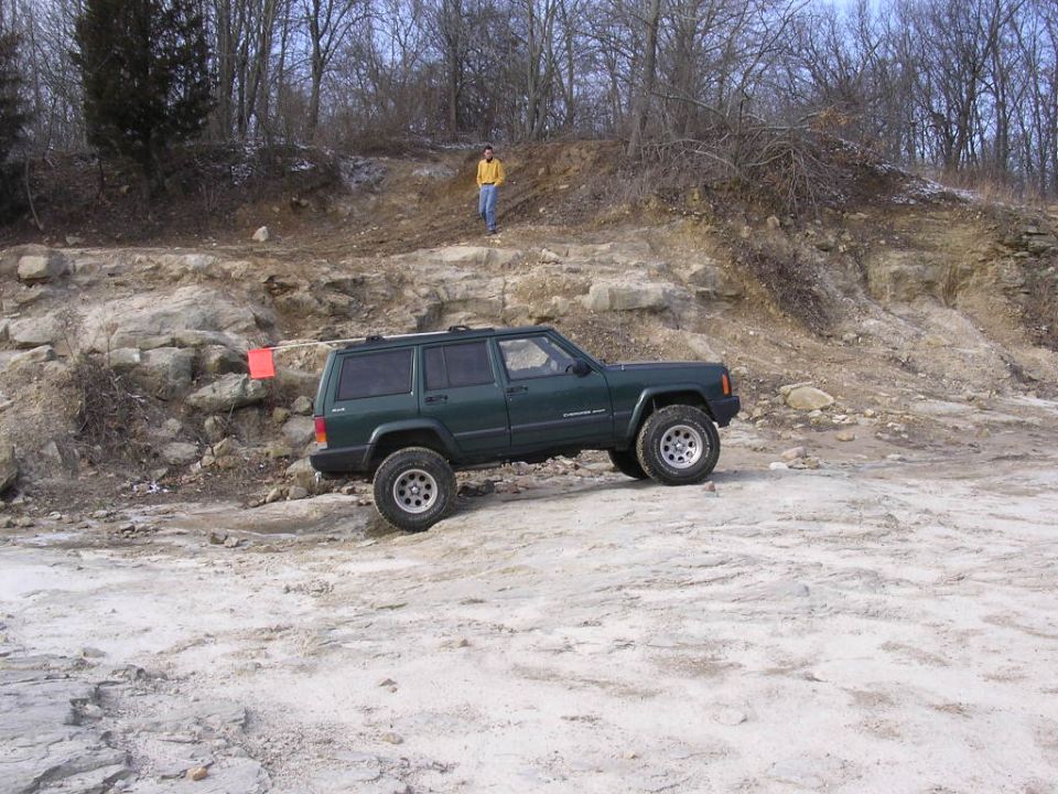 Green 1995 Jeep Cherokee on rocky off-road course