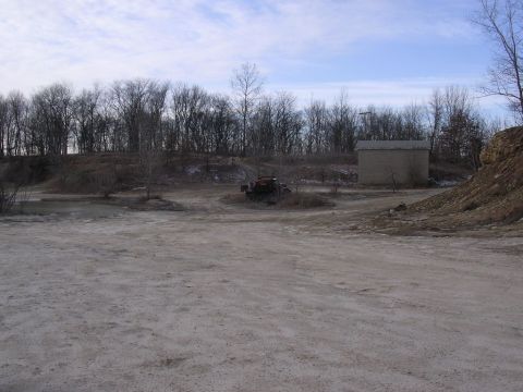1995 Jeep Cherokee - A 1995 Jeep Cherokee is seen parked in a rural outdoor setting with a building and trees visible.