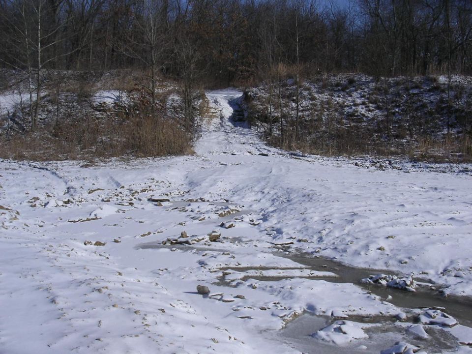 1995 Jeep Cherokee driving up a snowy, rocky incline