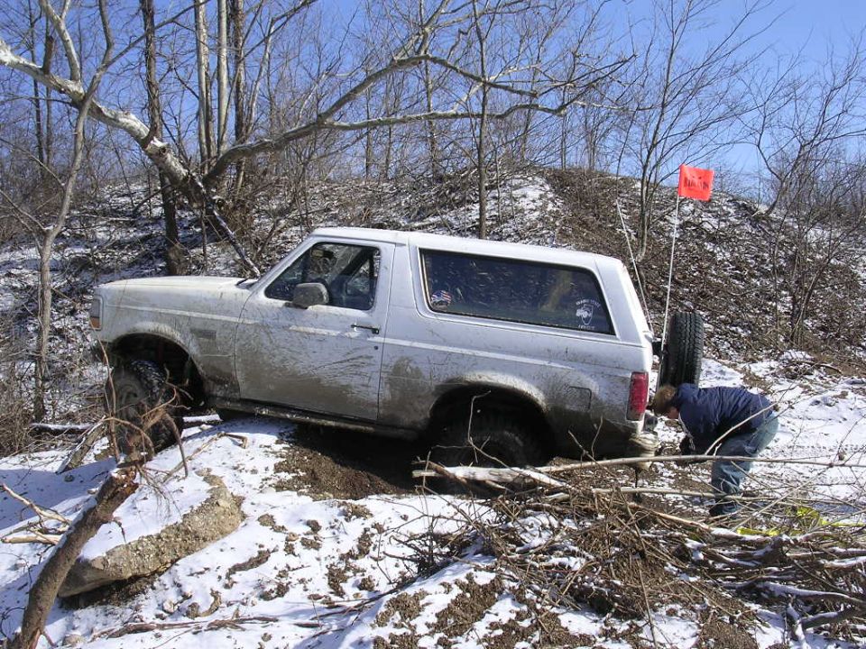 White Ford Bronco stuck in snow, side view