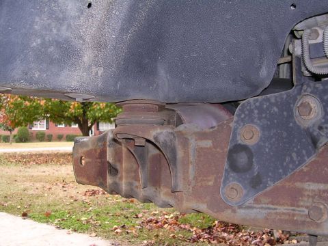 1995 Ford Bronco - This image shows the underside of a vehicle, focusing on the frame and suspension components with visible rust.