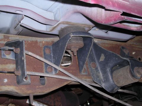 1995 Ford Bronco - Close-up view of the undercarriage, showing suspension and frame components with visible rust and wear.