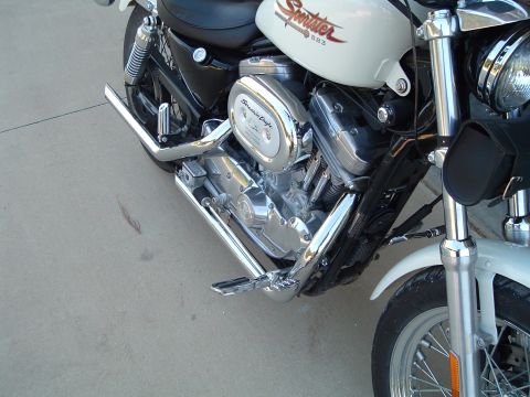 1995 Mercury Grand Marquis - Motorcycle engine detail with chrome accents and 'Sportster 883' branding on the tank.