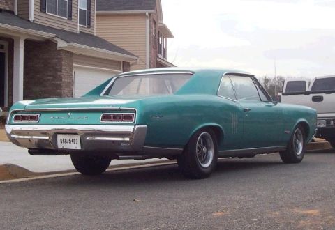 1967 Pontiac Lemans - Rear view of a teal 1967 Pontiac Lemans coupe parked on a street.