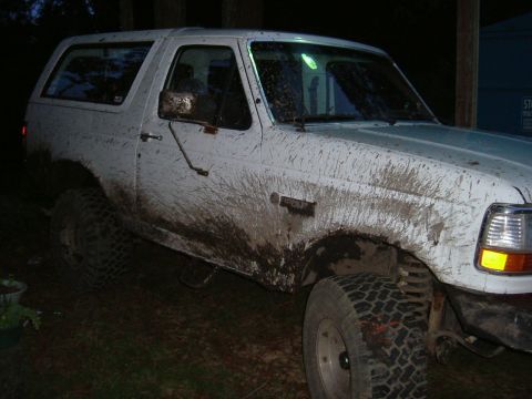 1993 Ford Bronco - This 1993 Ford Bronco is heavily covered in mud, suggesting it has been used off-road.