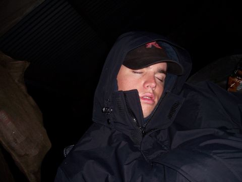 1998 Ford Ranger - A person is sleeping while wearing a hooded jacket and a baseball cap.