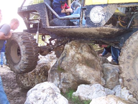 1998 Ford Ranger - An off-road vehicle is shown navigating a rocky terrain, with a person inside and another person assisting.
