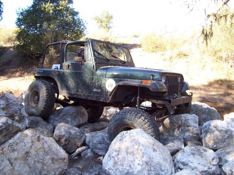 1998 Ford Ranger - Jeep Wrangler navigating a rocky trail. The vehicle appears to be from the early 1990s.