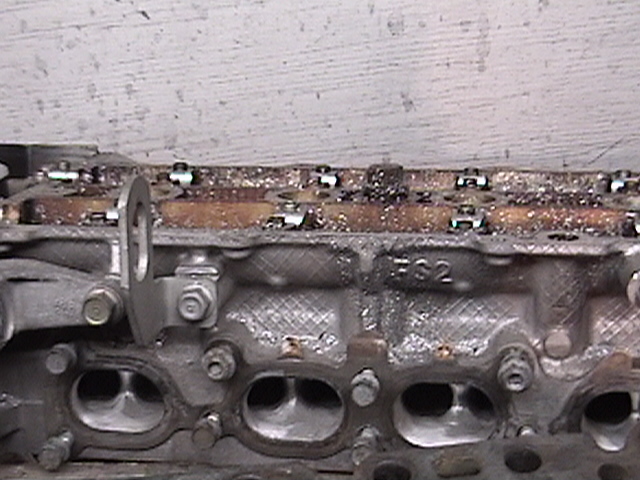 Removed cylinder head showing valves, ports and casting number