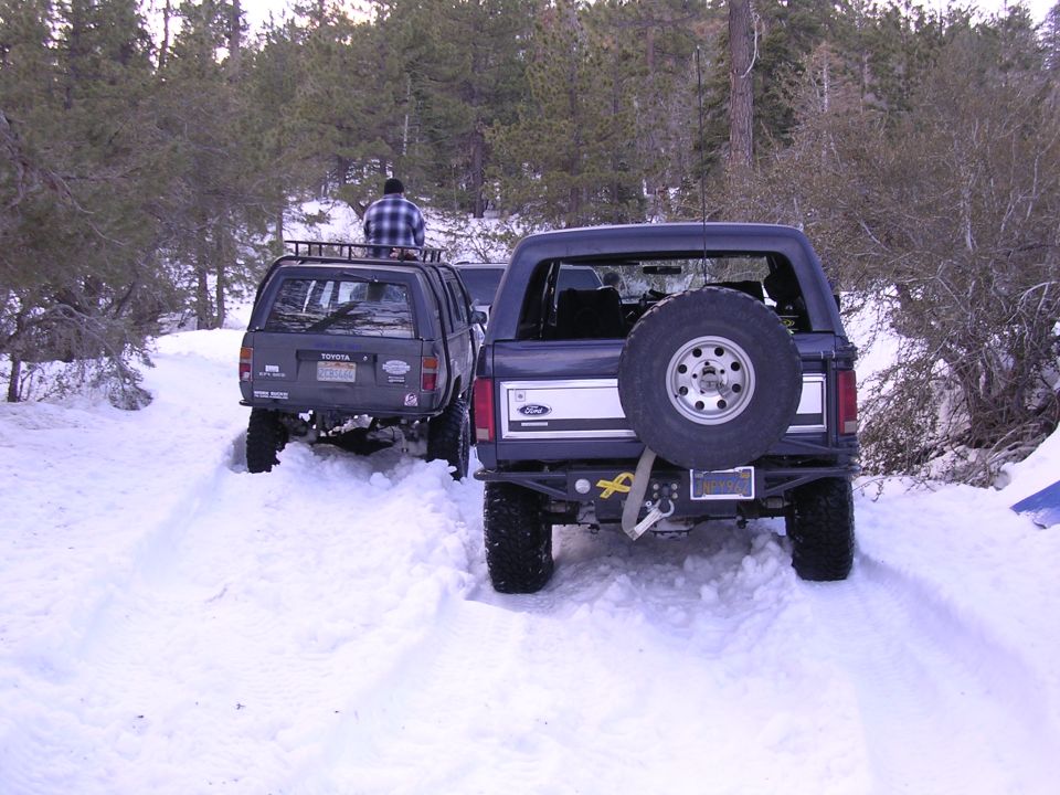Dark SUV with roof rack and Toyota badge in snow