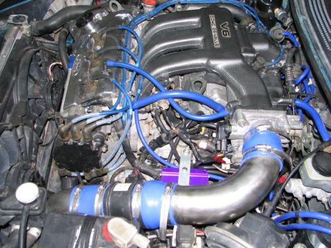 1994 Ford Probe - Close-up view of a car's engine bay, showing the V6 DOHC 24-valve intake manifold and other engine components.