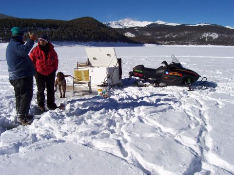 1994 Ford Bronco - Ice fishing scene with a snowmobile and shelter on a frozen lake.
