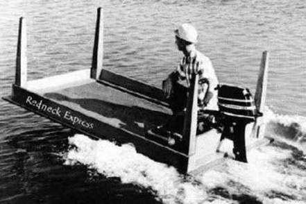 1979 Ford Bronco - A boat named Redneck Express moves through the water with a person at the helm and an outboard motor.