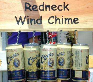 1979 Ford Bronco - A collection of Coors beer cans are repurposed as a wind chime, suspended from a wooden plank.