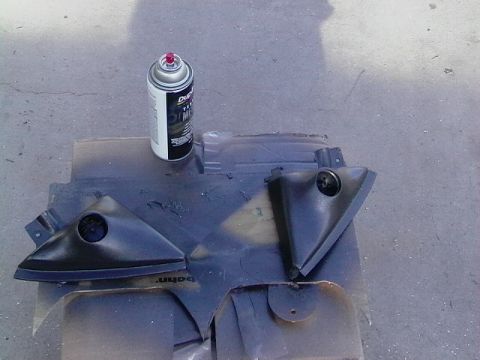 1999 Ford Taurus - Interior trim pieces are being prepped for painting with a can of spray paint.